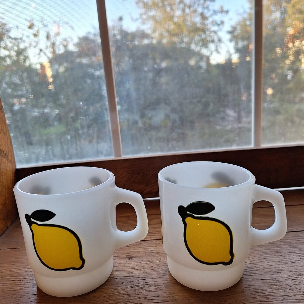Two vintage Fire king lemon stackable Mugs.